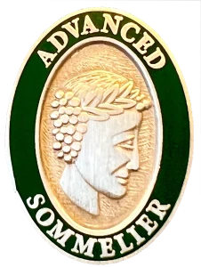 The Court’s Advanced Sommelier pin: the sommelier’s head in gold and silver, ringed in green and lettered Advanced Sommelier.
