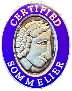 The Court’s Certified Sommelier pin: the sommelier’s head in silver, ringed in blue and lettered Certified Sommelier.